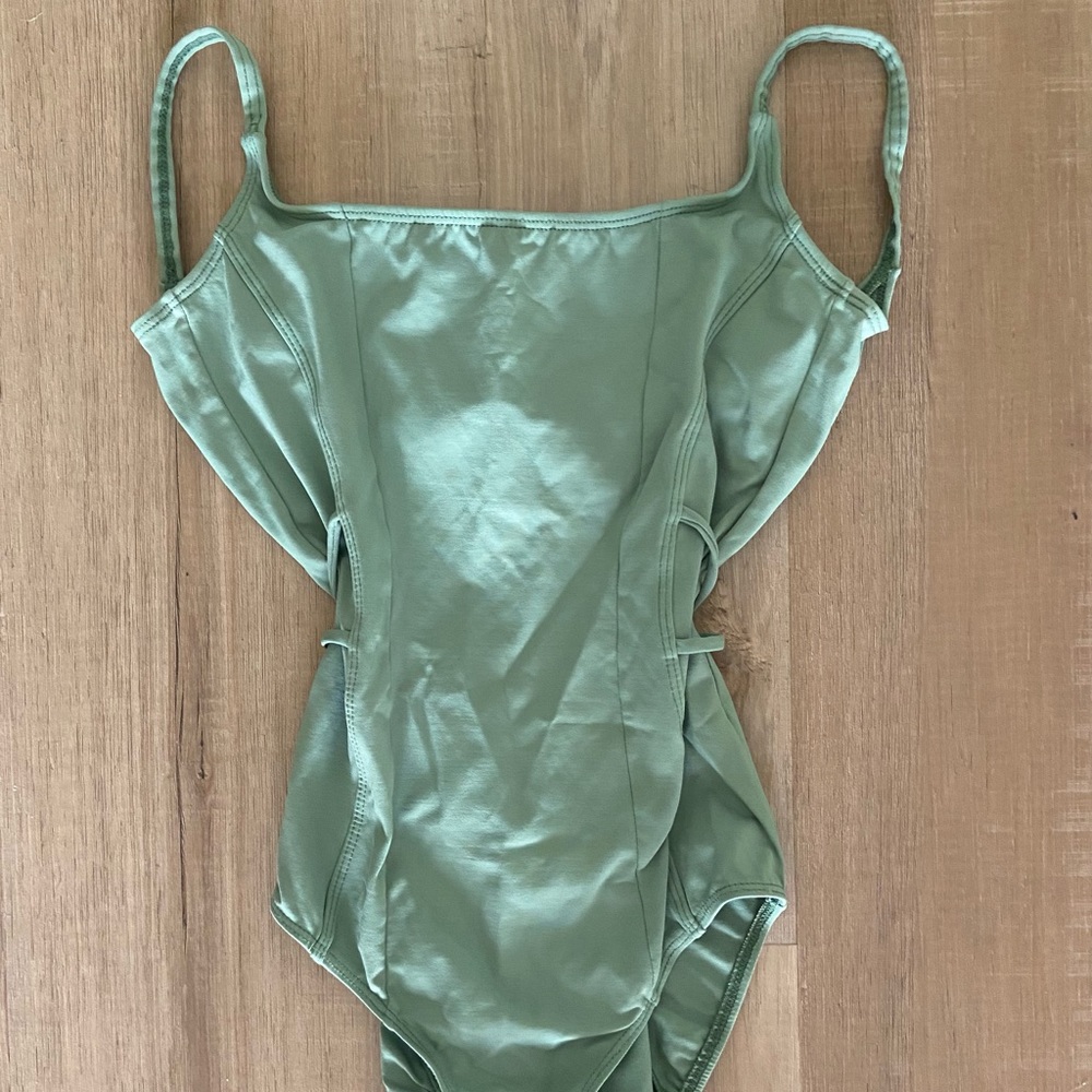 Pastel green leotard. Stunning low back.